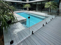 Commercial and residential architectural railing supplies featuring a frameless glass pool fence system with black spigots